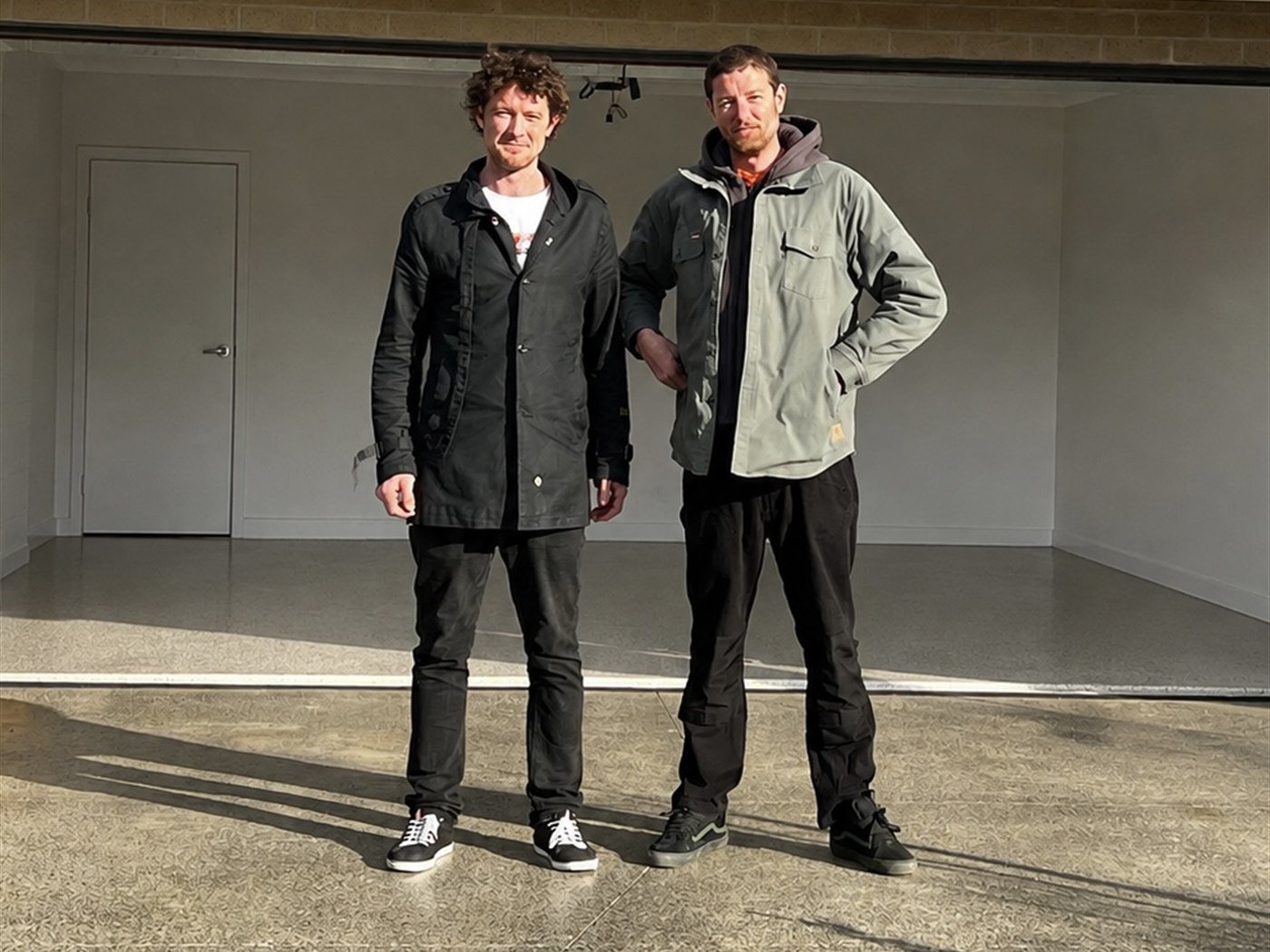 Rowan and Seamus Sercombe, owners of OEB, standing in a garage they have coated
